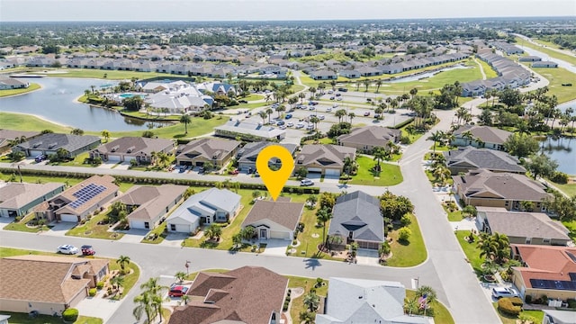 birds eye view of property with a water view and a residential view