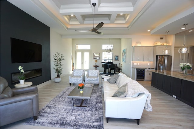 living room with wine cooler, french doors, crown molding, a towering ceiling, and coffered ceiling