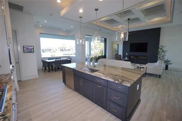 kitchen with visible vents, light wood-style flooring, stainless steel dishwasher, a sink, and coffered ceiling