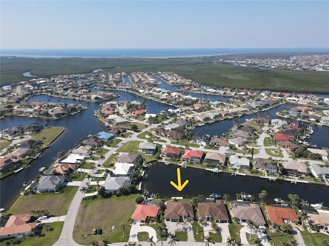 birds eye view of property with a residential view and a water view