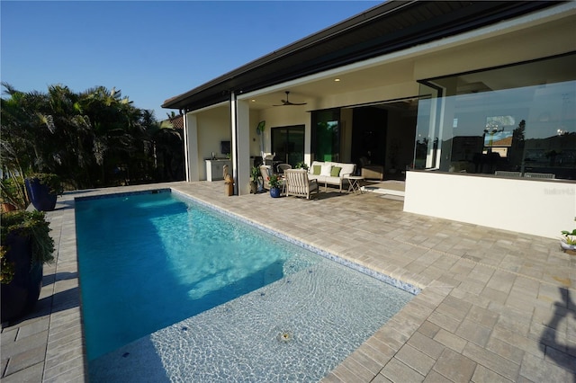 pool with a ceiling fan, a patio area, and outdoor lounge area