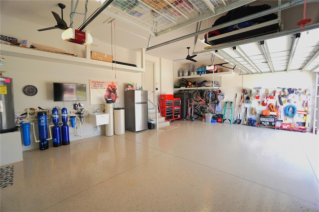 garage featuring a garage door opener, freestanding refrigerator, and water heater