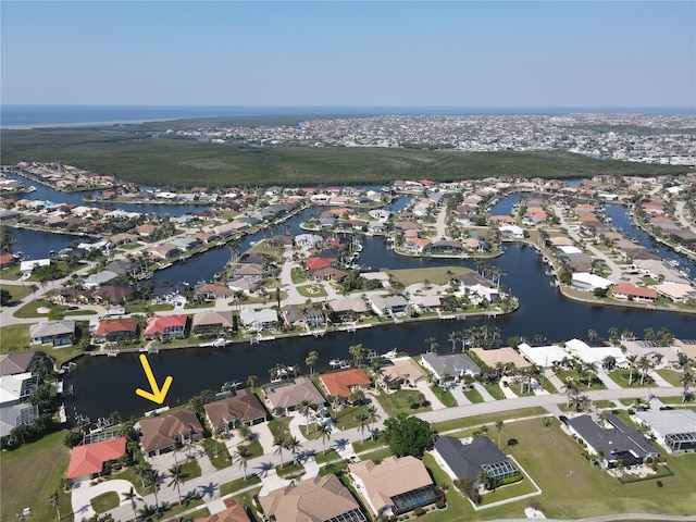 drone / aerial view featuring a water view and a residential view