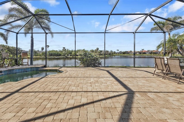 view of patio / terrace with a water view and a lanai