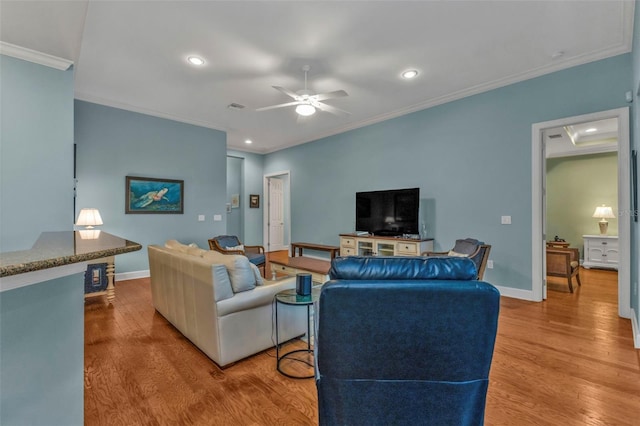 living area featuring crown molding, recessed lighting, ceiling fan, wood finished floors, and baseboards