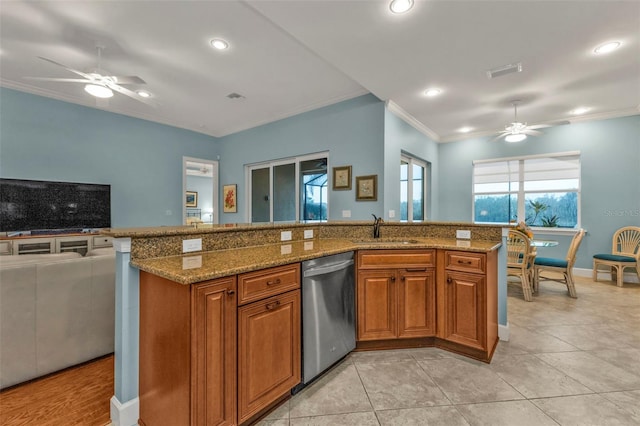 kitchen featuring brown cabinetry, ornamental molding, stainless steel dishwasher, stone counters, and a sink