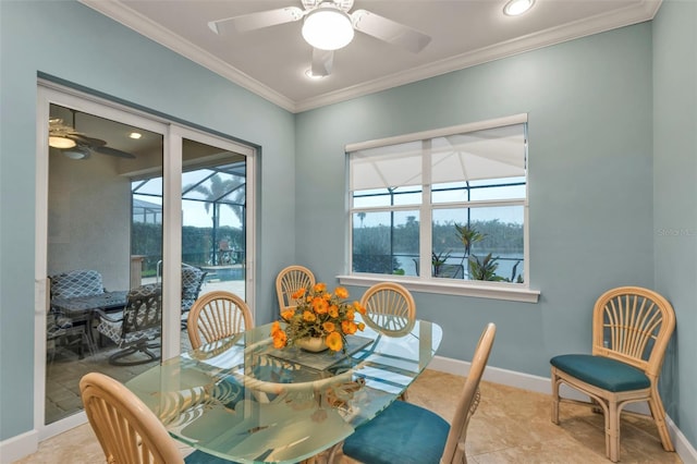 dining room featuring a sunroom, a ceiling fan, baseboards, and crown molding