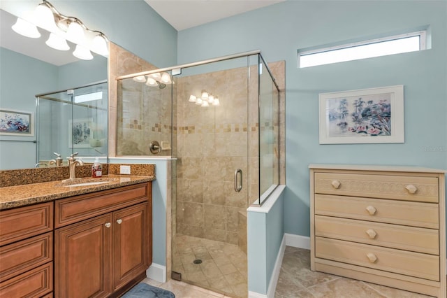 full bath with a shower stall, baseboards, and vanity