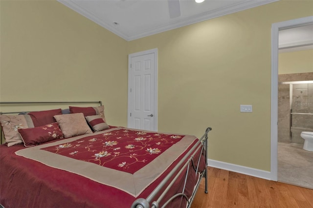 bedroom with baseboards, a ceiling fan, connected bathroom, wood finished floors, and crown molding