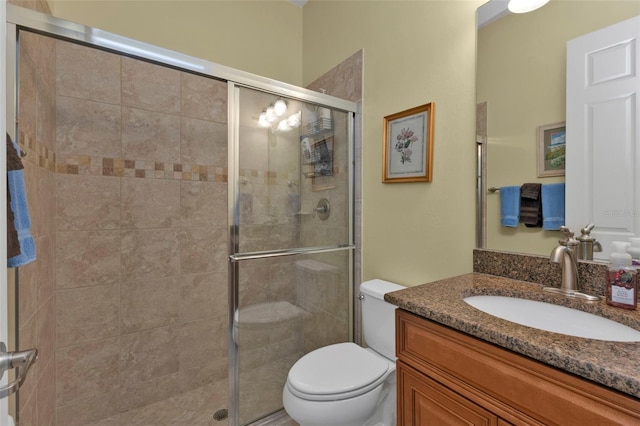 full bath with a shower stall, toilet, and vanity