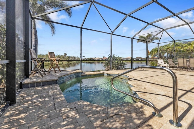 view of pool with a lanai, a patio area, a swimming pool, and a water view