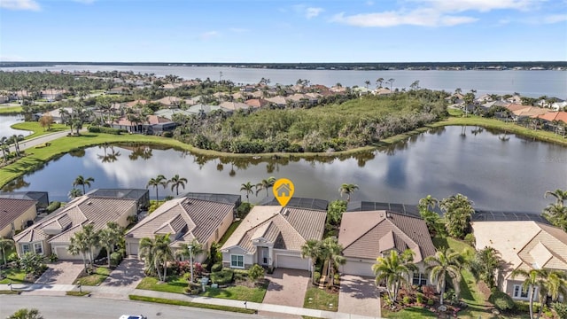 drone / aerial view with a water view and a residential view