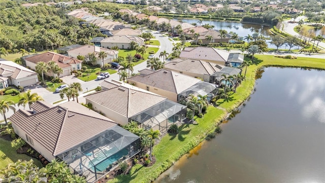 drone / aerial view with a water view and a residential view