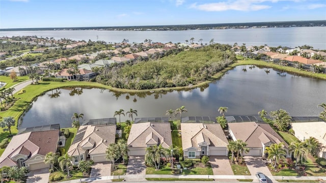 bird's eye view featuring a water view and a residential view