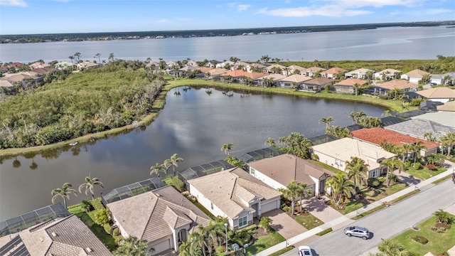 birds eye view of property with a residential view and a water view