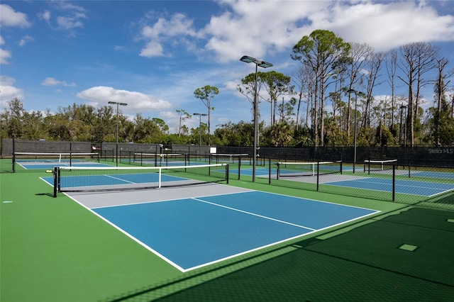 view of tennis court with fence