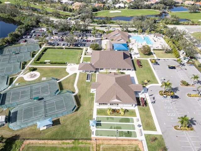 bird's eye view with view of golf course, a water view, and a residential view