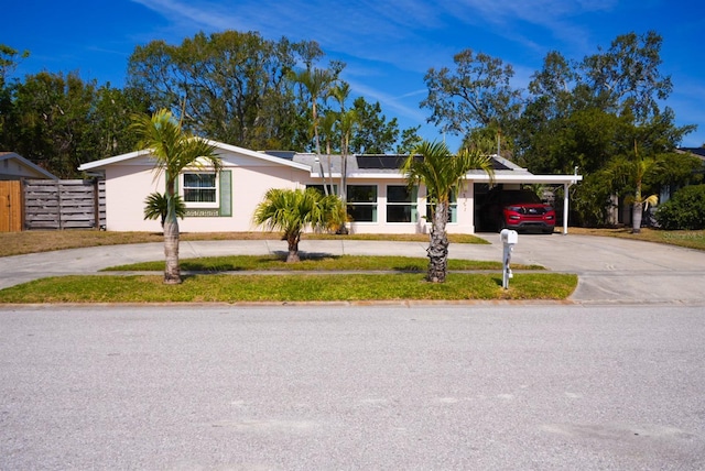 single story home featuring an attached carport and driveway