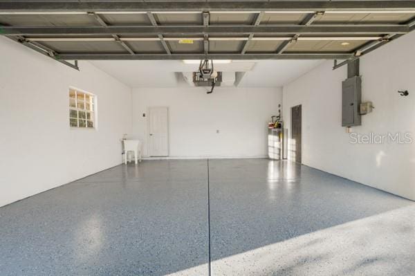 garage featuring electric panel and a garage door opener