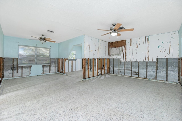 spare room with ceiling fan, speckled floor, a textured ceiling, and visible vents