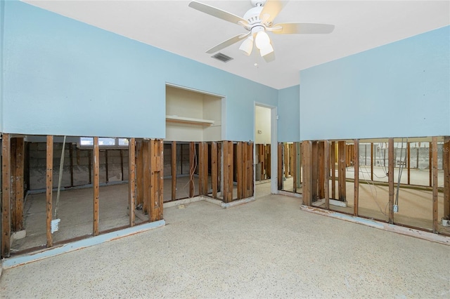 empty room with ceiling fan and visible vents