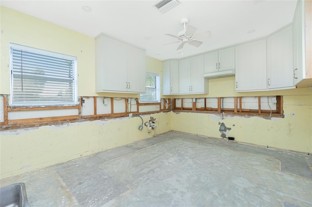 kitchen with ceiling fan, visible vents, and white cabinetry