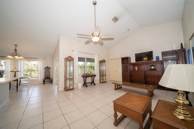 living area with ceiling fan with notable chandelier, light tile patterned flooring, visible vents, and baseboards