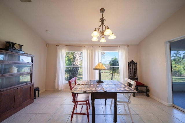 dining space with vaulted ceiling, light tile patterned floors, and an inviting chandelier