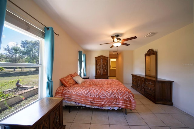 bedroom featuring light tile patterned floors, ceiling fan, and visible vents