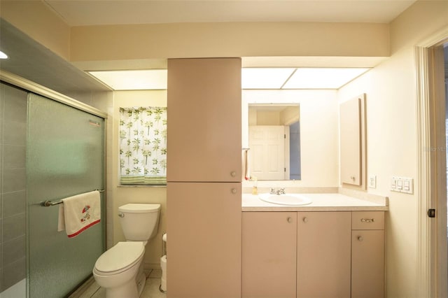 full bathroom featuring a shower stall, toilet, and vanity