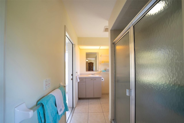 hallway with light tile patterned floors and a sink