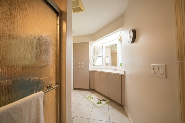 bathroom featuring tile patterned flooring, a shower stall, and vanity