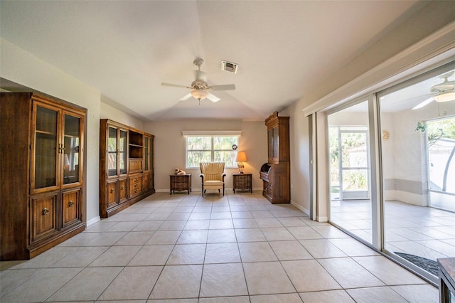 unfurnished room featuring light tile patterned floors, ceiling fan, visible vents, and baseboards