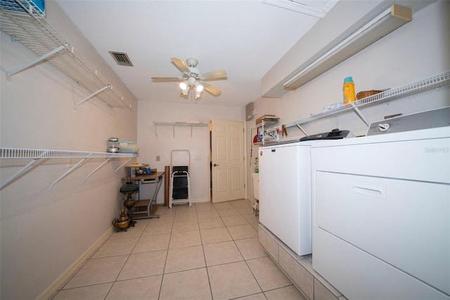 clothes washing area with laundry area, light tile patterned floors, visible vents, a ceiling fan, and separate washer and dryer