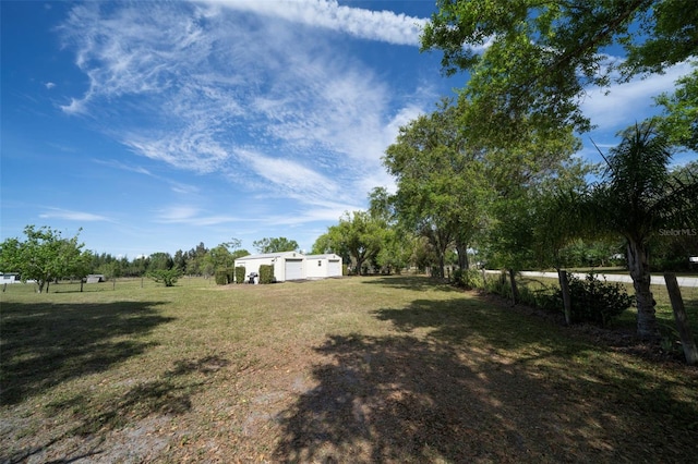 view of yard featuring an outbuilding and fence