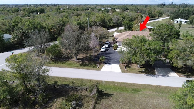 birds eye view of property with a view of trees