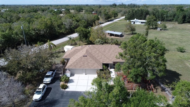 birds eye view of property with a wooded view