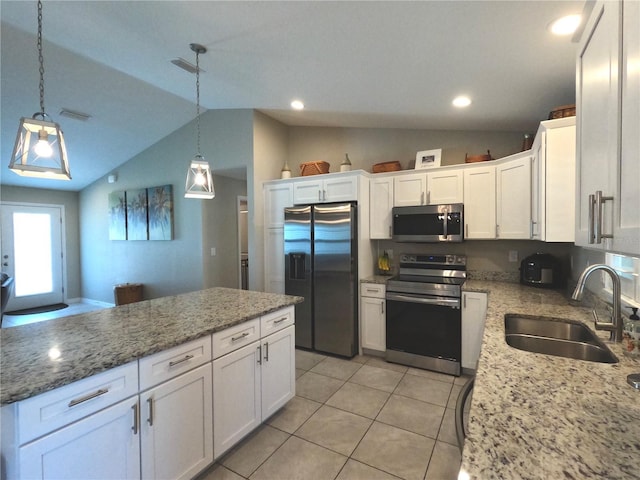 kitchen featuring hanging light fixtures, white cabinetry, appliances with stainless steel finishes, and a sink