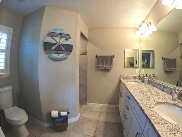 bathroom featuring toilet, a walk in shower, and a sink