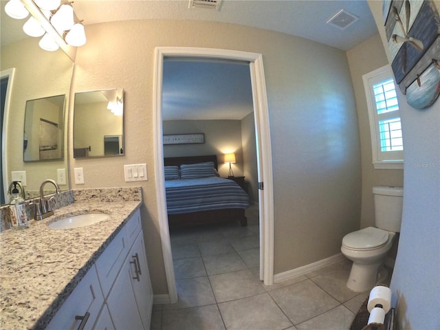 bathroom with toilet, vanity, visible vents, and tile patterned floors