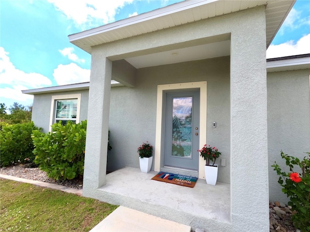 doorway to property with stucco siding