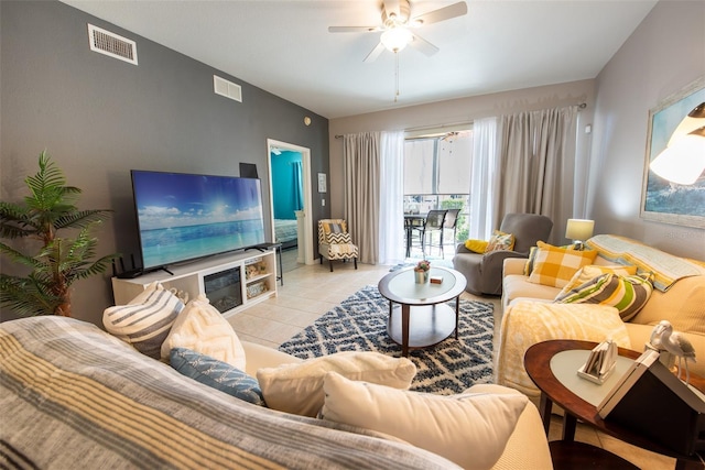 tiled living room with a ceiling fan and visible vents