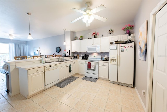 2002 Bal Harbor Blvd Unit 311, Punta Gorda, FL 33950 - kitchen with light tile patterned floors, white appliances, decorative light fixtures, a peninsula, and ceiling fan