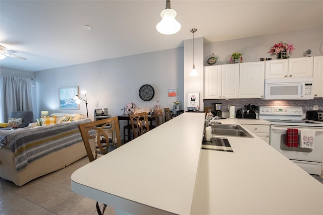 2002 Bal Harbor Blvd Unit 311, Punta Gorda, FL 33950 - kitchen with backsplash, light tile patterned floors, a sink, white appliances, and open floor plan