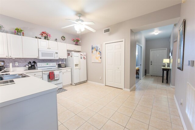 2002 Bal Harbor Blvd Unit 311, Punta Gorda, FL 33950 - kitchen with backsplash, visible vents, a ceiling fan, a sink, and white appliances