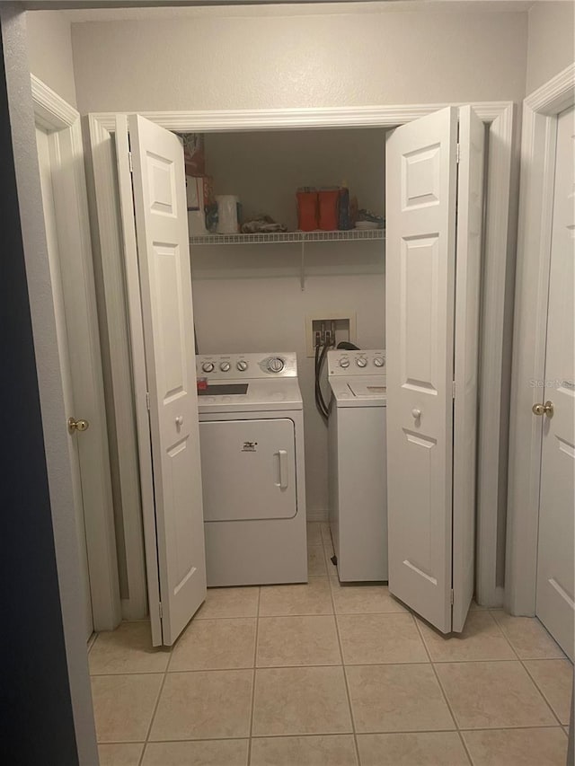 2002 Bal Harbor Blvd Unit 311, Punta Gorda, FL 33950 - laundry room featuring light tile patterned floors, independent washer and dryer, and laundry area