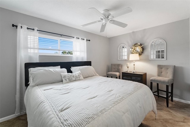 bedroom with ceiling fan and baseboards