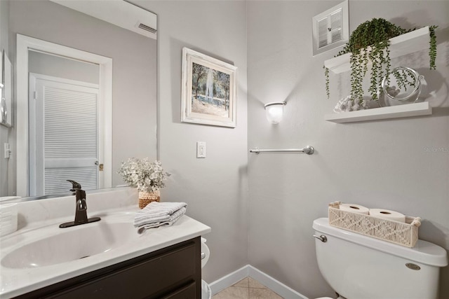 half bathroom featuring toilet, baseboards, visible vents, and vanity