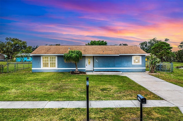 single story home with a front yard, fence, and stucco siding