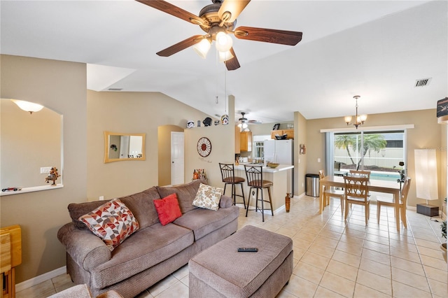 living area with light tile patterned floors, visible vents, ceiling fan with notable chandelier, and vaulted ceiling